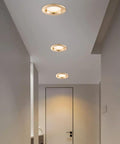 Top Shelf 9 Pack 3 Inch LED Recessed Downlights With Sleek Baffle Trim illuminating a hallway with warm glow.