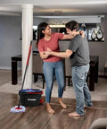 Couple in living room with RinseClean Spin Mop And Bucket System For Clean Water Mopping Lets You Clean With Clean Water From Start To Finish