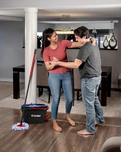 Couple in living room with RinseClean Spin Mop And Bucket System For Clean Water Mopping Lets You Clean With Clean Water From Start To Finish