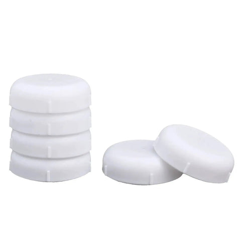 Top Shelf Heavy Duty Wrought Iron Reinforced Patio Furniture Feet Caps 140 Pack White Chair Leg Glides stacked and side by side.