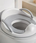 No Fuss Potty Training Toilet Seat For Toddlers with sturdy handles on a standard toilet, features a grippy non-slip base.