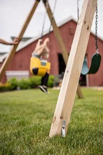 Playset Anchor Kit for Swing Sets Heavy Duty Ground Anchors securing wooden swing set outdoors