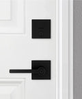 Matte Black Keyed Entry Lever And Deadbolt Combo With SmartKey For Easy Lockup installed on a white door