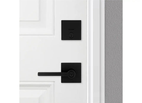 Matte Black Keyed Entry Lever And Deadbolt Combo With SmartKey For Easy Lockup installed on a white door