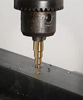 Pro Grade 3 Piece Step Drill Bit Set With Titanium Coated High Speed Steel drilling into metal, showcasing two-flute design.