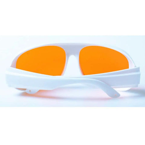 Premium Od5 Plus Laser Safety Glasses Featuring Snug Fit Frames Blocking Violet Blue And Green Beams From 266Nm Up To 540Nm CE EN207 Certified Work Ready Protective Goggles with orange lenses and white frame.