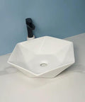 USZWBY Vessel Sinks Hexagonal Art Basin Sink Ceramic Wash Table Hotel Bathroom Single Bathroom Bowl Sink on a white counter.