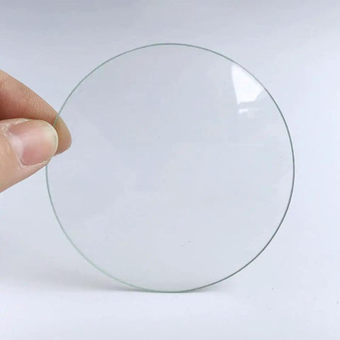 Person holding a piece of the Lab Watch Glass Set With Beaker Cover Lids, 3.9 Inch Diameter, 12 Pieces, Thickened High Transparency Glassware