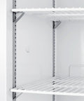 Interior view of Commercial Upright Freezer 18 Cu Ft Left Handed Door Swing with white shelves and sturdy metal support brackets.
