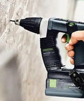 Hand using Hardcore No Fuss Cordless Construction Screwdriver With Brushless Motor Tech for driving screws into a wall.
