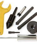Powermatic lathe accessory kit with yellow wrench, chucks, adapters, and mounting flange.