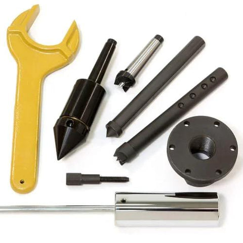Powermatic lathe accessory kit with yellow wrench, chucks, adapters, and mounting flange.
