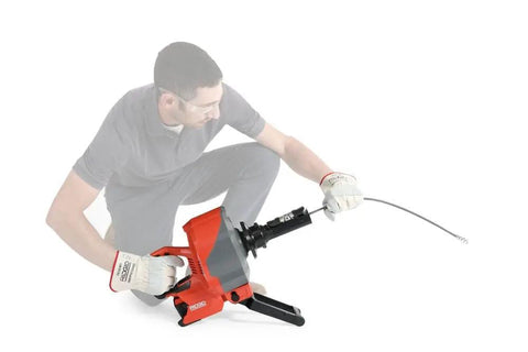 Heavy Duty Cordless Drain Snake With Brushless Motor And Twenty Five Foot Steel Cable Blasts Away Stubborn Clogs in use.