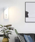 Smooth Led Wall Sconce With Hassle Free Switch And Quick Usb Port Cast From Tough Iron Packs A Slick Matte Black Look And Reliable 4000k Glow Perfect For Bedrooms, Hallways, Garages, Restaurants And Home Offices mounted on a wall with a plant and artwork.