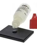 Waytest 18K gold testing solution bottle with red cap and dropper over black testing tile