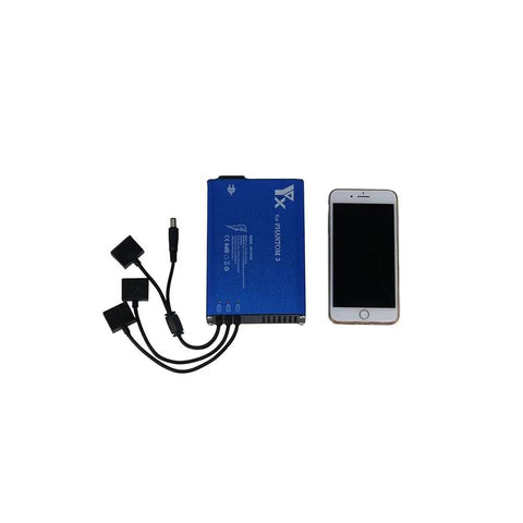 4 In 1 Parallel Power Hub For Phantom 3 Drone Battery Transmitter Charger, Built To Last With A Blue Aluminum Shell next to phone