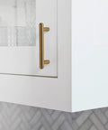 Close-up of Six Pack 3-Inch Classic Curvature Cabinet Handles in Antique Brass on a kitchen cabinet door.