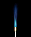 Self Igniting Outdoor Torch, 20,000 BTU High Output Flame, blue flame from nozzle against black background