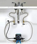 Fully Automatic Instant Hot Water Recirculation Pump For Under Sink Setup With Zero Wait Time And Super Slick Energy Saving Design For Easy Living installed beneath sink with polished faucets and flexible tubing.