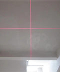 Image showing the 650nm Red Cross Line Module for Indoor Positioning and Crosshair Alignment projecting red cross lines on a ceiling.