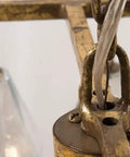 Close-up of the brass chain and fixture of the French Inspired Long Pendant Chandelier Featuring Prismatic Glass Panels.