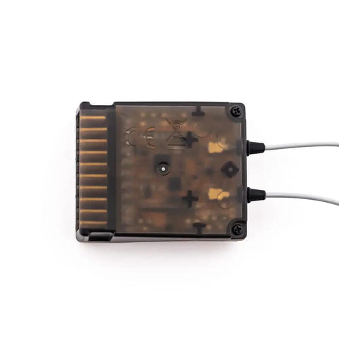 Top view of FTR12B 2.4GHz 12CH AFHDS 3 dual antenna receiver showing transparent casing and multiple connection ports.