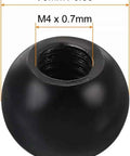 Close-up of single black steel ball style M4 thread cap nut, 9mm diameter, black finish for light fixtures and furniture.