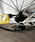 Applying High Performance Penetrating Oil For Bike Chain Lubrication to bicycle gears to stop squeaks and protect metal.