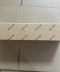 Front view of brown cardboard box with repeating KRETLAW branding for grease gun kit