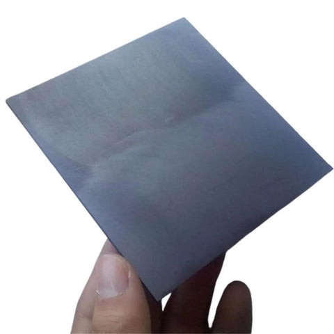 Hand holding one sheet from Five Pack Carbon Graphite Sheets 20x20x2mm for 3D Printing Crucibles and Tools, Square Ingot Blocks.