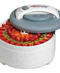 No Nonsense 500 Watt Food Dehydrator Featuring Adjustable Temp Dial And Top Mounted Fan For Steady Airflow, filled with sliced fruit.
