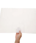 Person holding a sheet from 100 Sheets Newsprint Packing Paper for Moving and Shipping against a white background