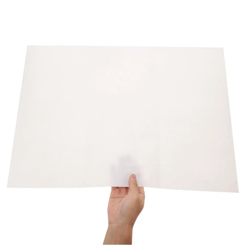 Person holding a sheet from 100 Sheets Newsprint Packing Paper for Moving and Shipping against a white background
