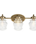 Janiel 24 Inch Three Light Vanity Light with clear glass shades in classic bronze finish, ideal for above the mirror installation.