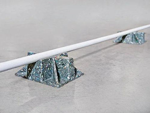 Saddle support rooftop pipe stand bases in speckled blue recycled-plastic, supporting a pipe on concrete