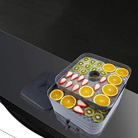 No Sweat Digital Food Dehydrator With Roomy Stackable Trays showing dried oranges and kiwi slices on trays.