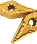 Close-up of gold carbide turning inserts with center hole; pair for CNC lathe steel machining