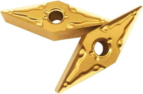 Close-up of gold carbide turning inserts with center hole; pair for CNC lathe steel machining