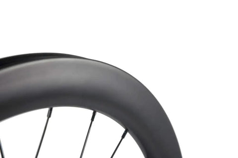 Close-up of Carbon Disc Wheelset 50C-25 Clincher With Center Lock 12x100 Thru Axle, aerodynamic deep rim design.