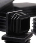 Close-up of 100 Pack 1 Inch Square Plastic Tube End Plugs For 1 Inch Outside Diameter Square Tubing, durable black chair glide caps