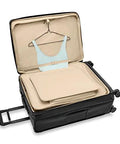 Open Briggs & Riley expandable spinner luggage showing interior features for men's and women's travel needs.