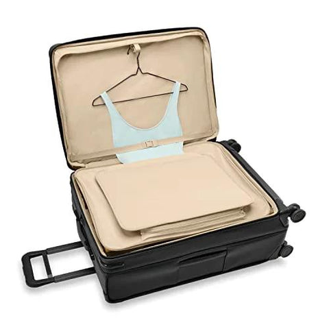 Open Briggs & Riley expandable spinner luggage showing interior features for men's and women's travel needs.