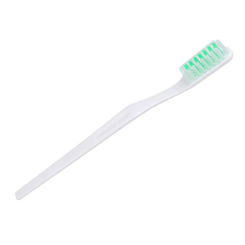 White toothbrush with green bristles, designed for effective teeth cleaning and dental hygiene.