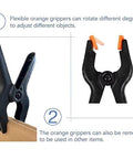 Front view of plastic spring clamps, 4.5 in, black with orange tips; 10-pack for crafts and backdrops