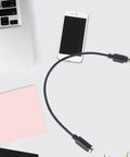 Black PS2 Male To Female Extension Cord Round Port Peripheral Adapter connecting a laptop to a retro keyboard.