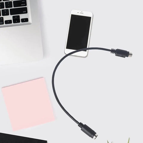 Black PS2 Male To Female Extension Cord Round Port Peripheral Adapter connecting a laptop to a retro keyboard.