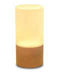 Cozy Beech Wood Table Lamp With Dimmable LED Light, glowing softly, cylindrical shape, compact design for bedside and desk use.