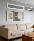 Heavy Duty 19X19 Aluminum Return Air Vent Cover With Removable Mesh Filter And Louvered Wall Grille For Hvac Systems above a beige couch in a modern living room.