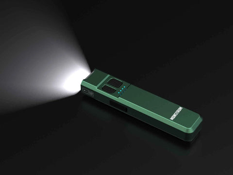 Tracer 1000 Lumens Ultra Slim EDC Flashlight Forest Green Blue Beat The Dark With A Pocket Friendly 4.4 X 1.0 X 0.5 Inch Frame And 2.8 Oz Weight Multi Mode Beam For Everyday Carry Camping Hiking And Late Night Jobs shown on black background, emitting bright light.