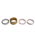 Waterjet seal kit components (4 rings) for intensifier pump: silver seal, brass bushing, white seals with red inserts.